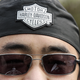 A Chinese motorcycle enthusiast wears a Harley-Davidson headband outside the newly-opened Harley-Davidson dealership in Beijing on April 8, 2006.